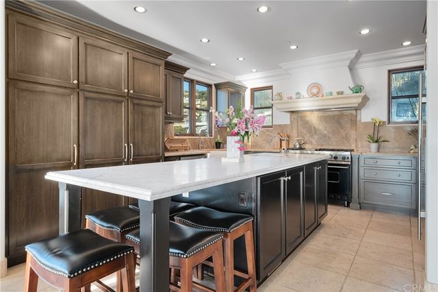 a kitchen with stainless steel appliances a sink stove and cabinets