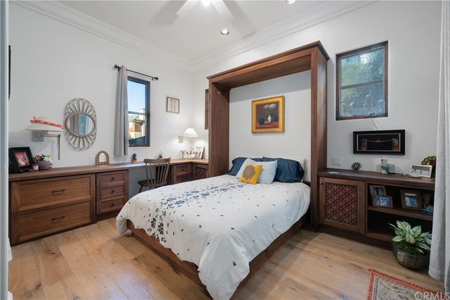 a bedroom with a bed and wooden dresser