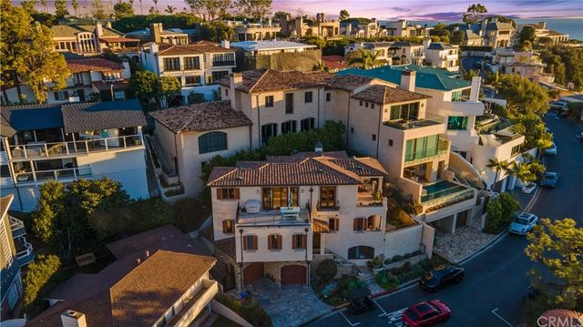 an aerial view of a house with garden space and street view