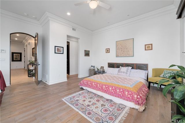 a bedroom with a bed and a chandelier