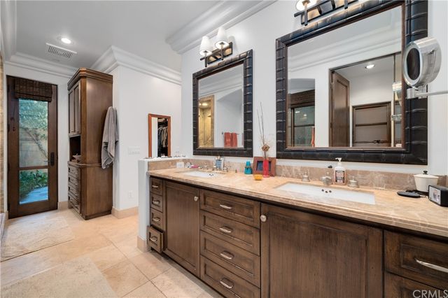 a bathroom with a double vanity sink and a mirror