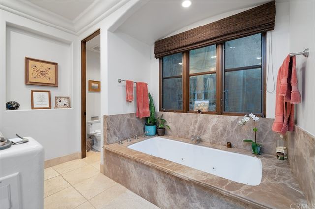 a bath tub sitting in a bathroom next to a window