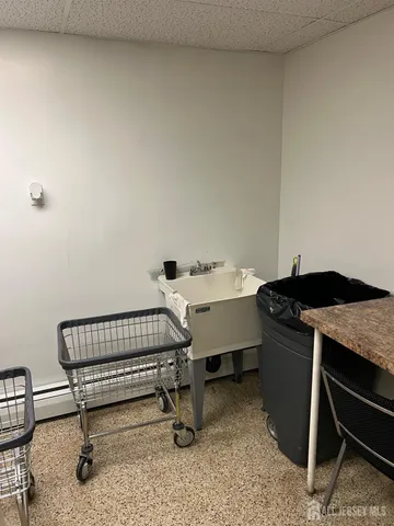 a living room with furniture a chandelier and a fireplace
