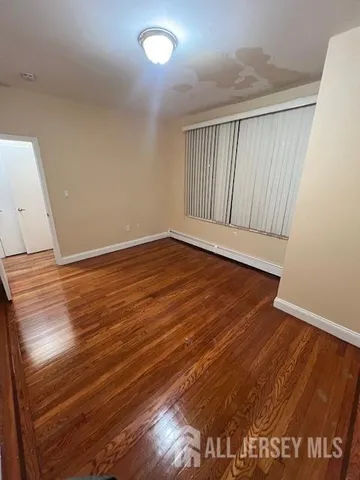 an empty room with wooden floor