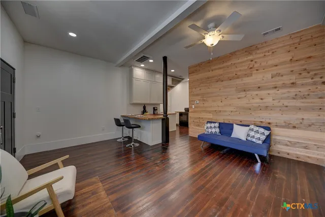 a view of a livingroom with furniture and wooden floor