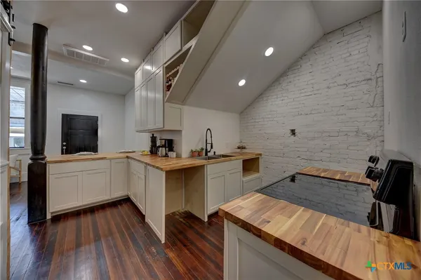 a kitchen with a sink cabinets and appliances