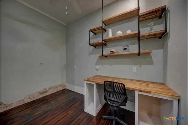 a kitchen with a sink and wooden floor
