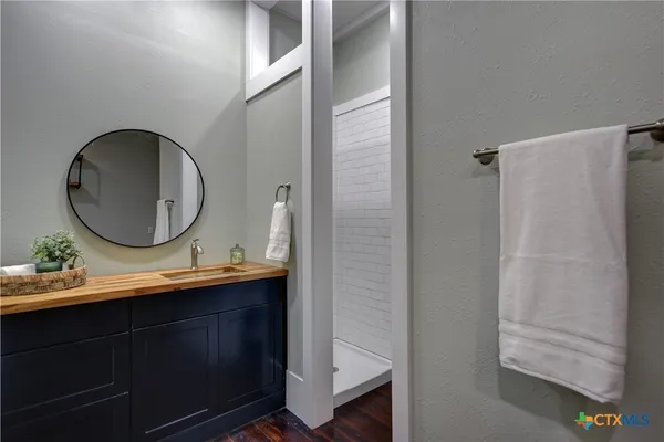 a bathroom with a sink mirror and vanity