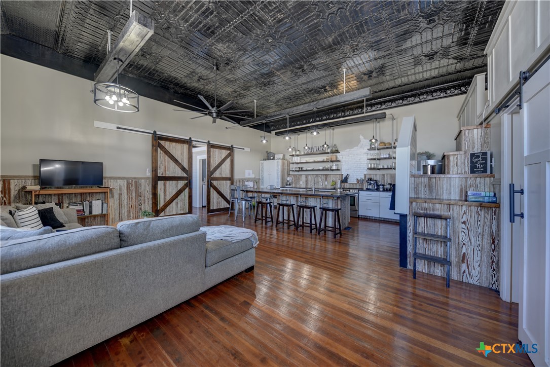 103 North Main Street, Unit B Moulton, TX 77975 - Photo 2 of 28 a living room with furniture and a flat screen tv