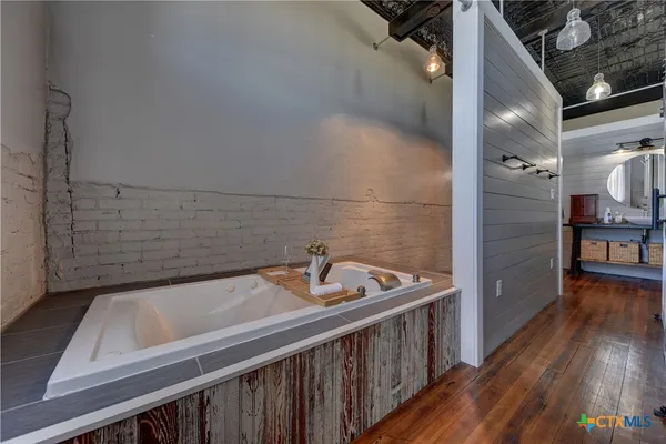 a bathroom with a tub and sink