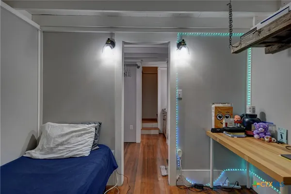 a view of a hallway with wooden floor and closet