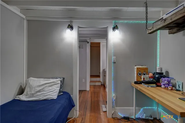 a view of a hallway with wooden floor and closet