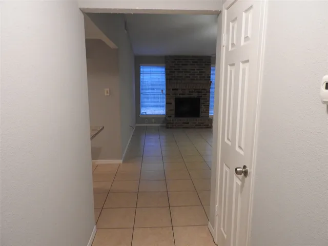 a view of entryway and hallway with a white door