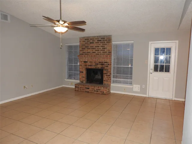 an empty room with fireplace