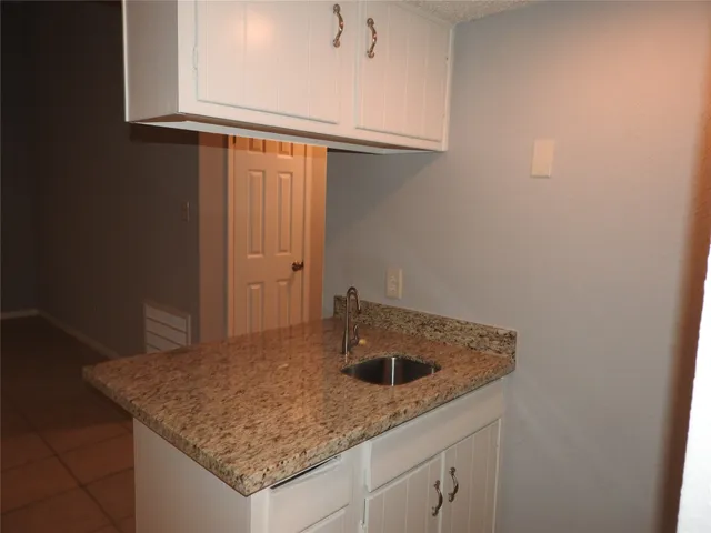 a kitchen with a sink and cabinets