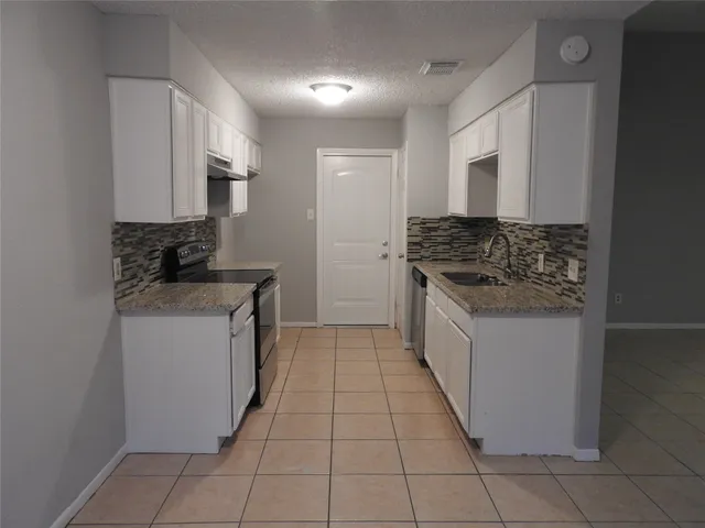 a kitchen with a stove and a sink