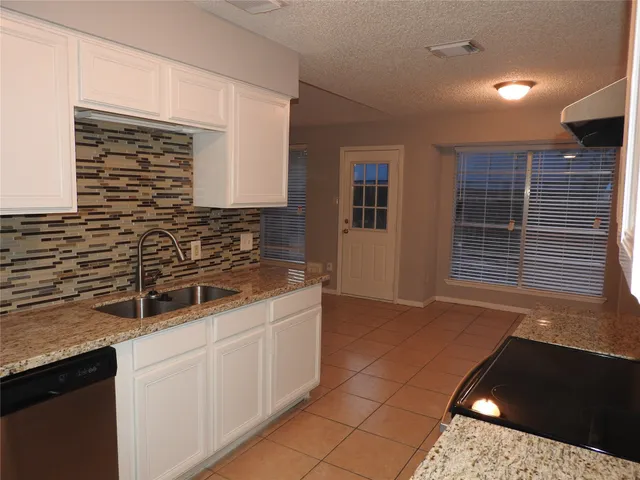 a kitchen with a sink and cabinets