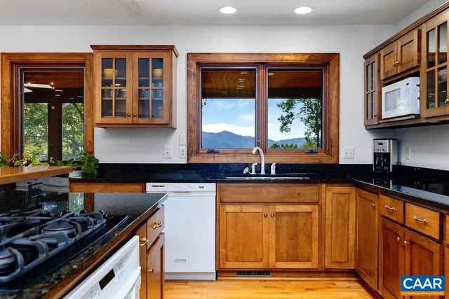 a kitchen with stainless steel appliances granite countertop a stove and a sink