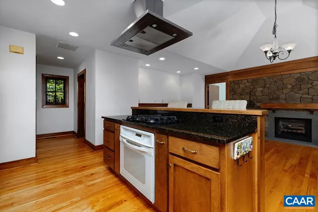 a kitchen with stainless steel appliances granite countertop a stove a sink and a refrigerator