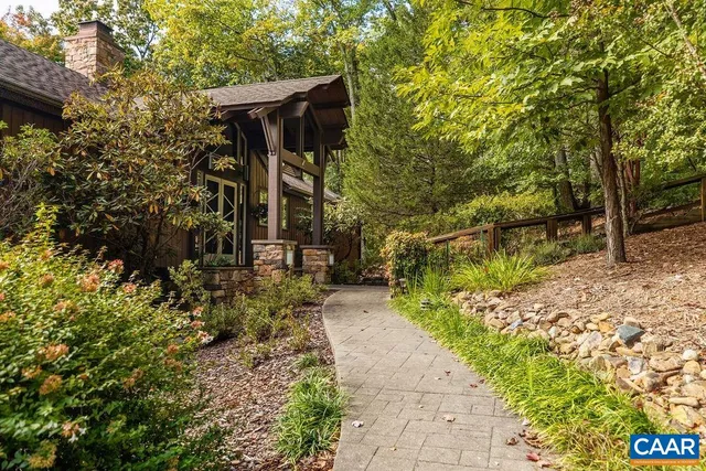 a view of a pathway of a house with a yard