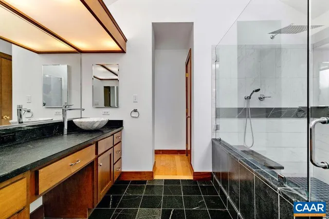 a bathroom with double vanity and a shower