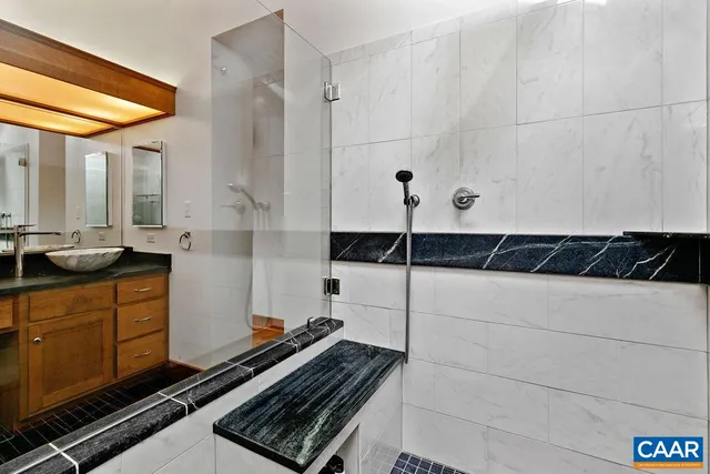 a view of walk in closet with clothes