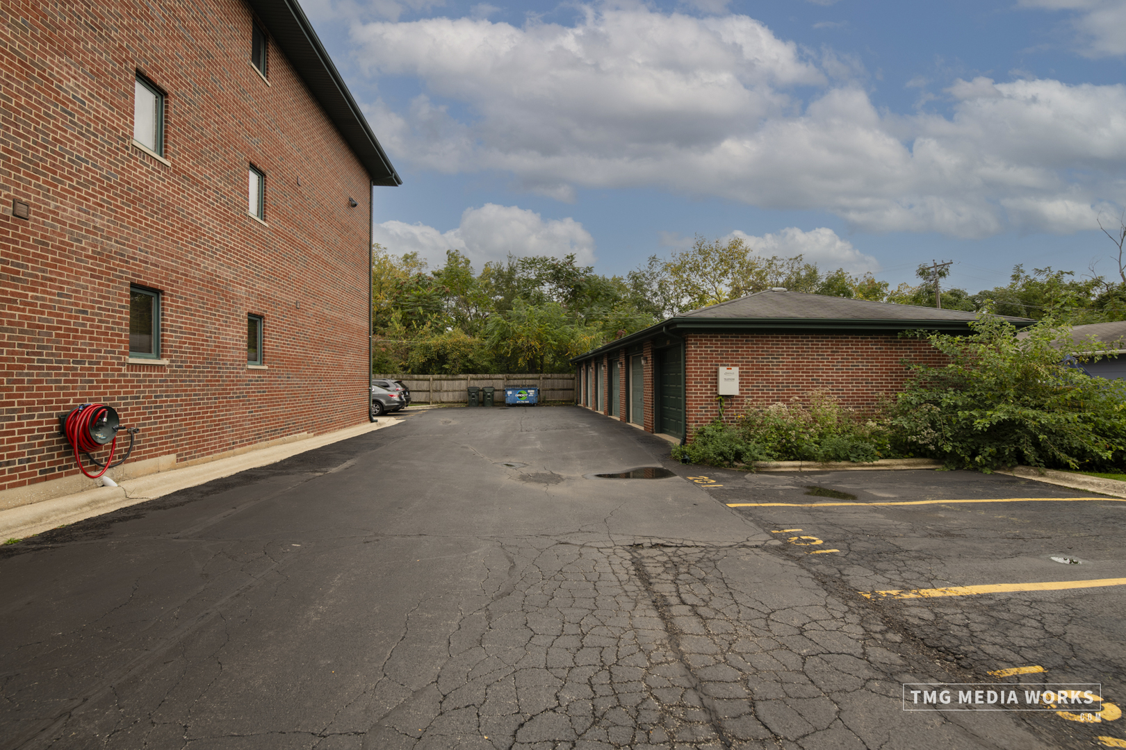616 East 5th Avenue, Unit 101 Naperville, IL 60563 - Photo 28 of 57 a view of a backyard with plants and a garage