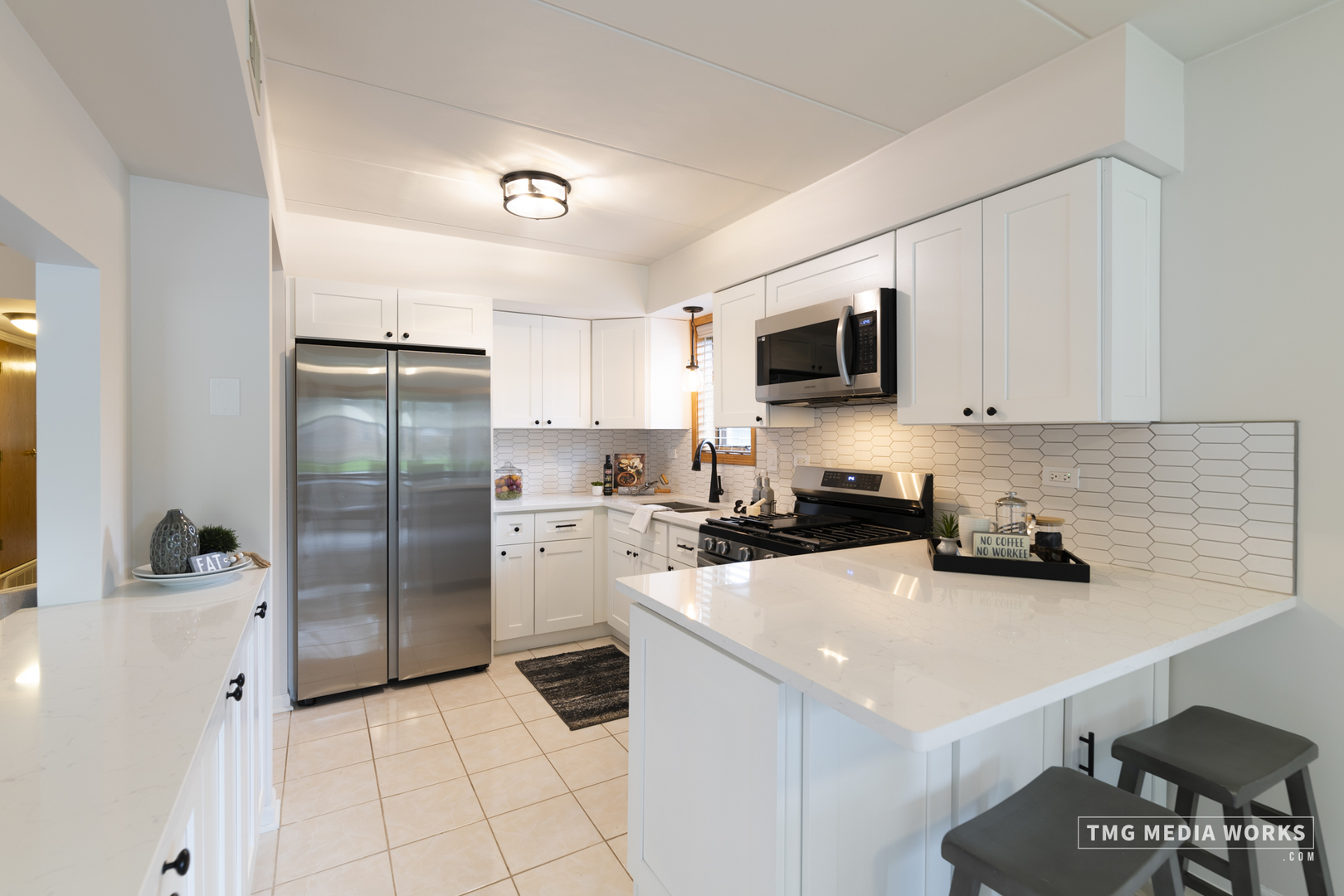 616 East 5th Avenue, Unit 101 Naperville, IL 60563 - Photo 7 of 57 a kitchen with a sink a refrigerator and cabinets