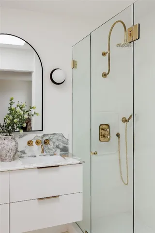 a bathroom with a granite countertop sink and a mirror