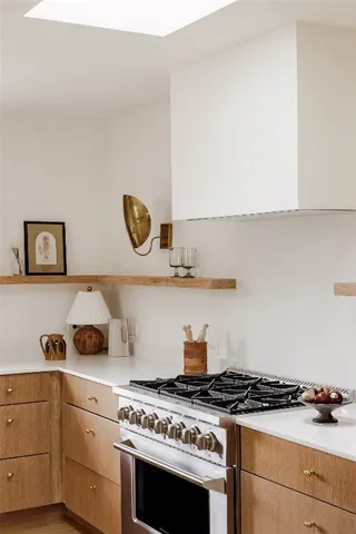 a white stove top oven sitting inside of a kitchen