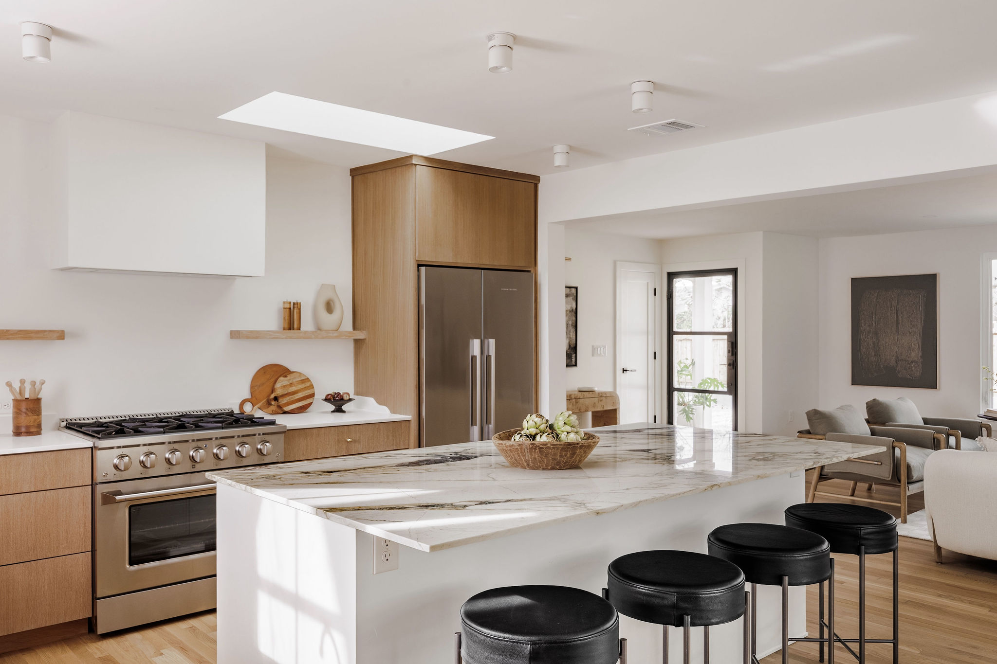 4515 Bull Creek Road Austin, TX 78731 - Photo 9 of 33 Host effortlessly from the oversized island while staying connected to the living space—this kitchen was built for casual mornings, dinner parties, and everything in between.
