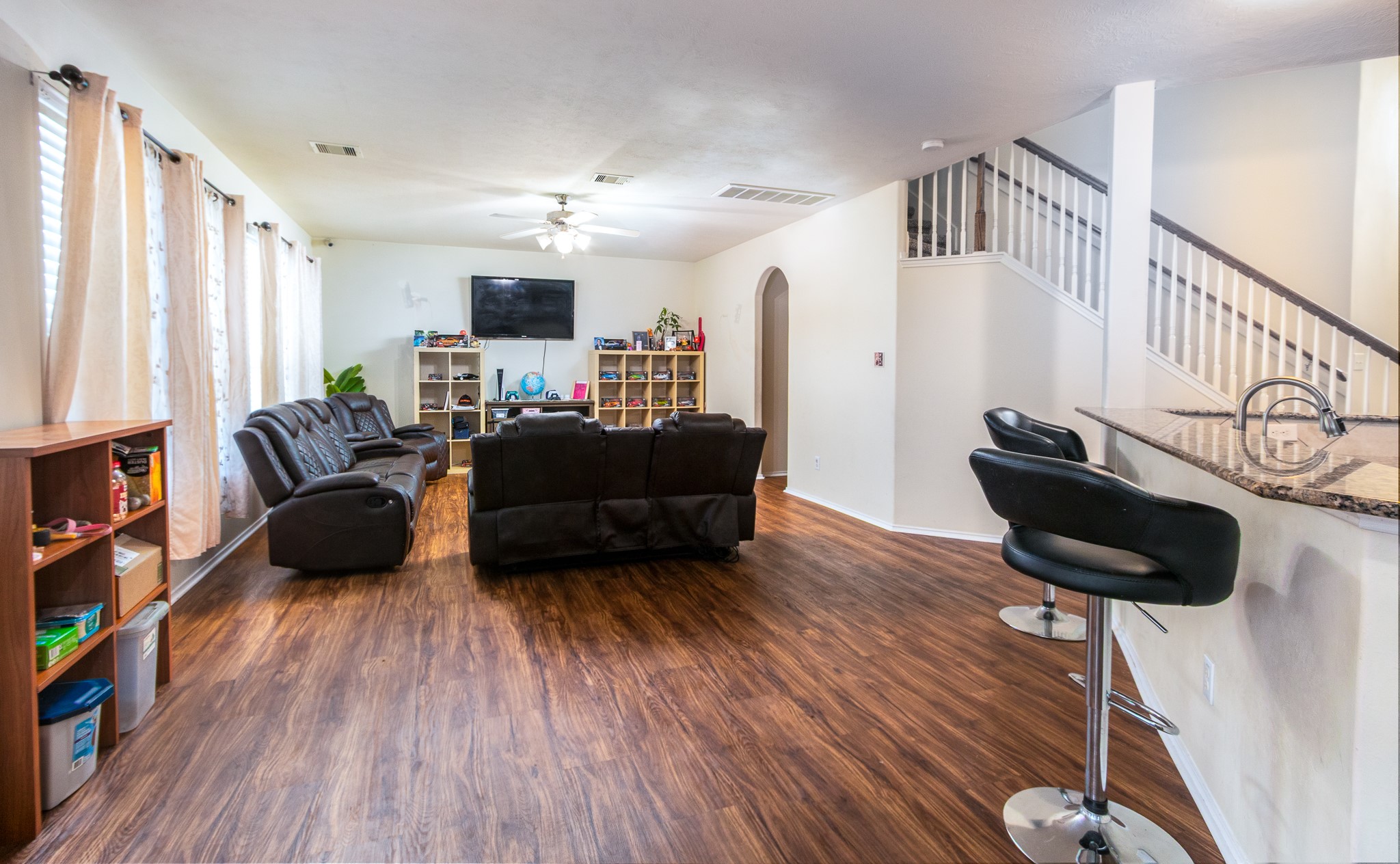 1107 Arum Road Missouri City, TX 77489 - Photo 8 of 23 This super spacious family room is filled with an abundance of natural light and features recent laminate flooring & ceiling fan and is perfectly situated just off the kitchen.
