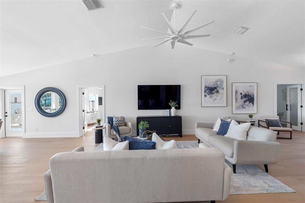 517 Johns Pass Avenue Madeira Beach, FL 33708 - Photo 15 of 92 a living room with furniture a clock and a flat screen tv