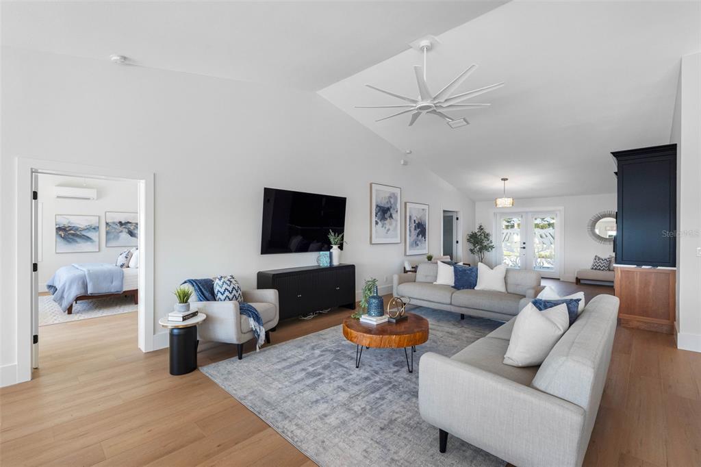 517 Johns Pass Avenue Madeira Beach, FL 33708 - Photo 17 of 92 a living room with furniture and a flat screen tv