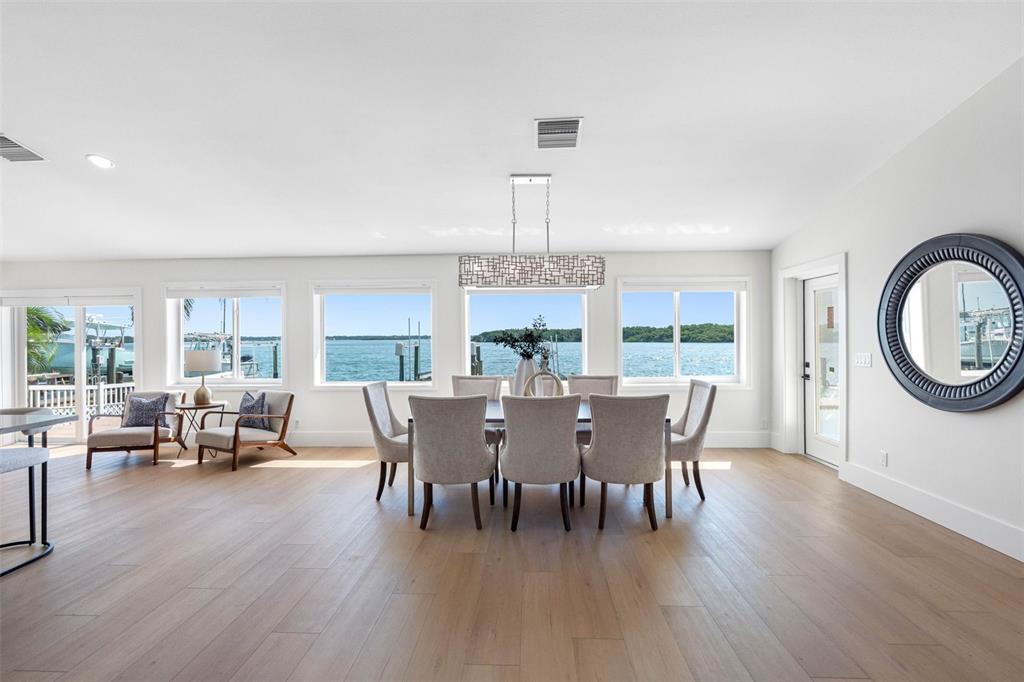 517 Johns Pass Avenue Madeira Beach, FL 33708 - Photo 21 of 92 a view of a dining room with furniture window and wooden floor