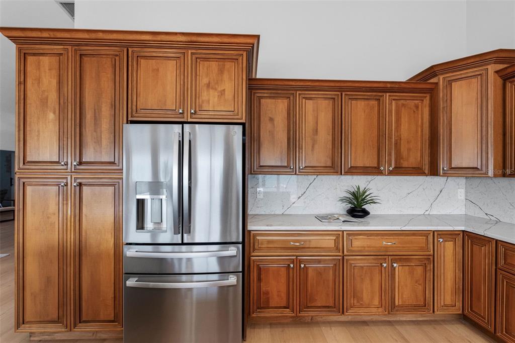 517 Johns Pass Avenue Madeira Beach, FL 33708 - Photo 39 of 92 a kitchen with stainless steel appliances granite countertop a refrigerator and cabinets