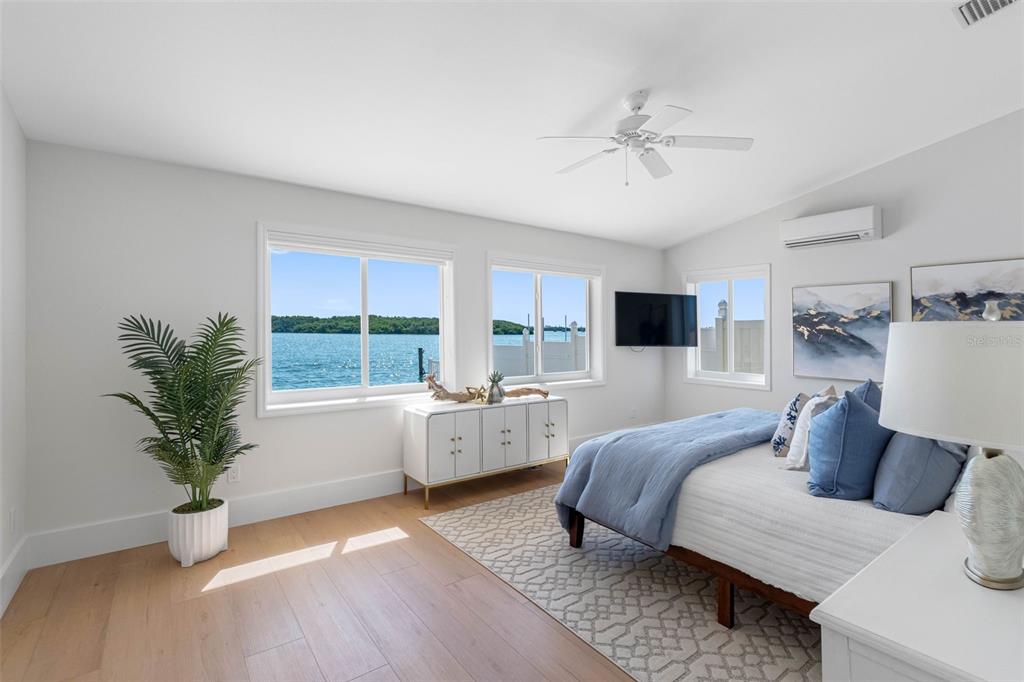 517 Johns Pass Avenue Madeira Beach, FL 33708 - Photo 41 of 92 a spacious bedroom with a bed and a potted plant