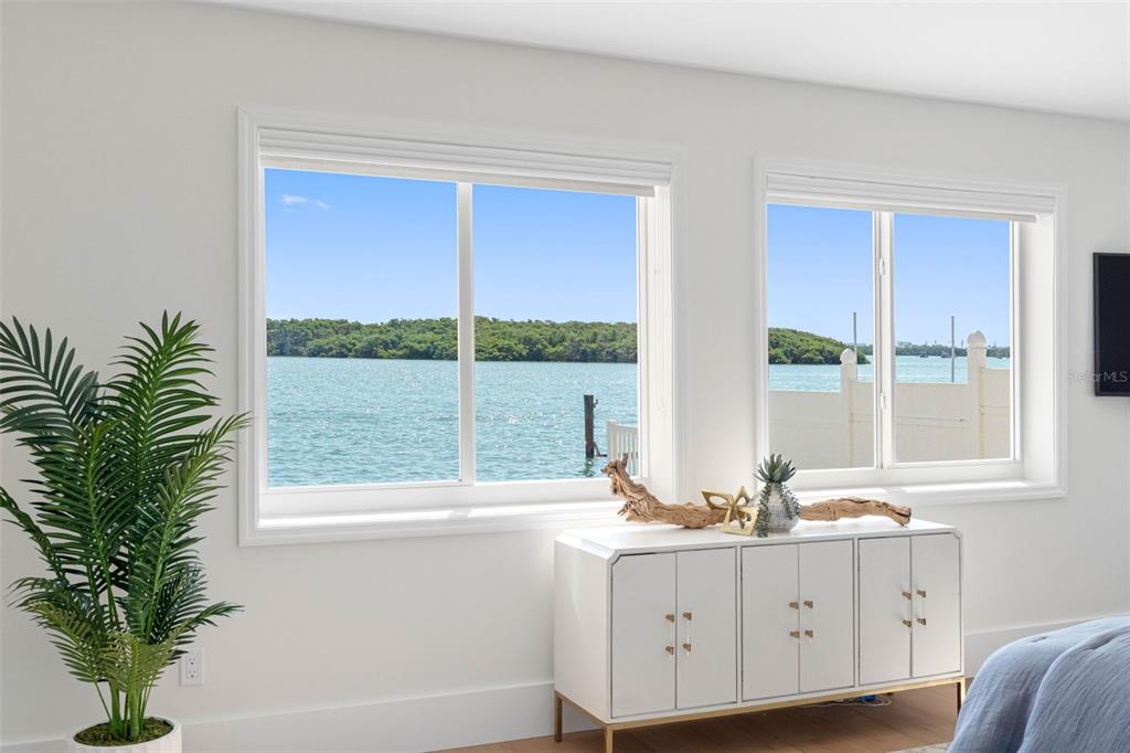517 Johns Pass Avenue Madeira Beach, FL 33708 - Photo 42 of 92 a bathroom with a large window a sink and a potted plant
