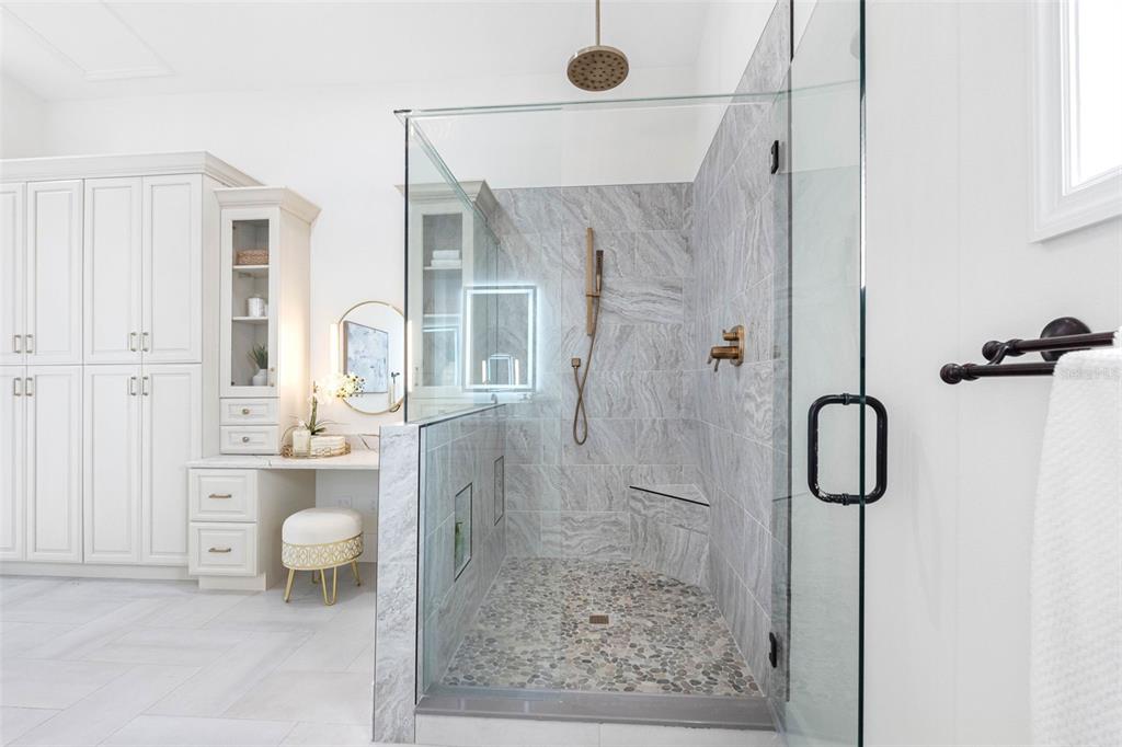 517 Johns Pass Avenue Madeira Beach, FL 33708 - Photo 49 of 92 a bathroom with a granite countertop shower a mirror and a sink