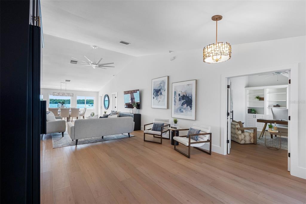517 Johns Pass Avenue Madeira Beach, FL 33708 - Photo 10 of 92 a view of a dining room with furniture wooden floor and a chandelier