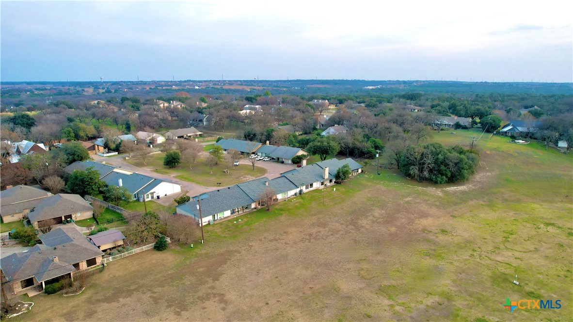 1710 Old Mill Road, Unit 12 Salado, TX 76571 - Photo 36 of 42 an aerial view of a houses with a yard and lake view