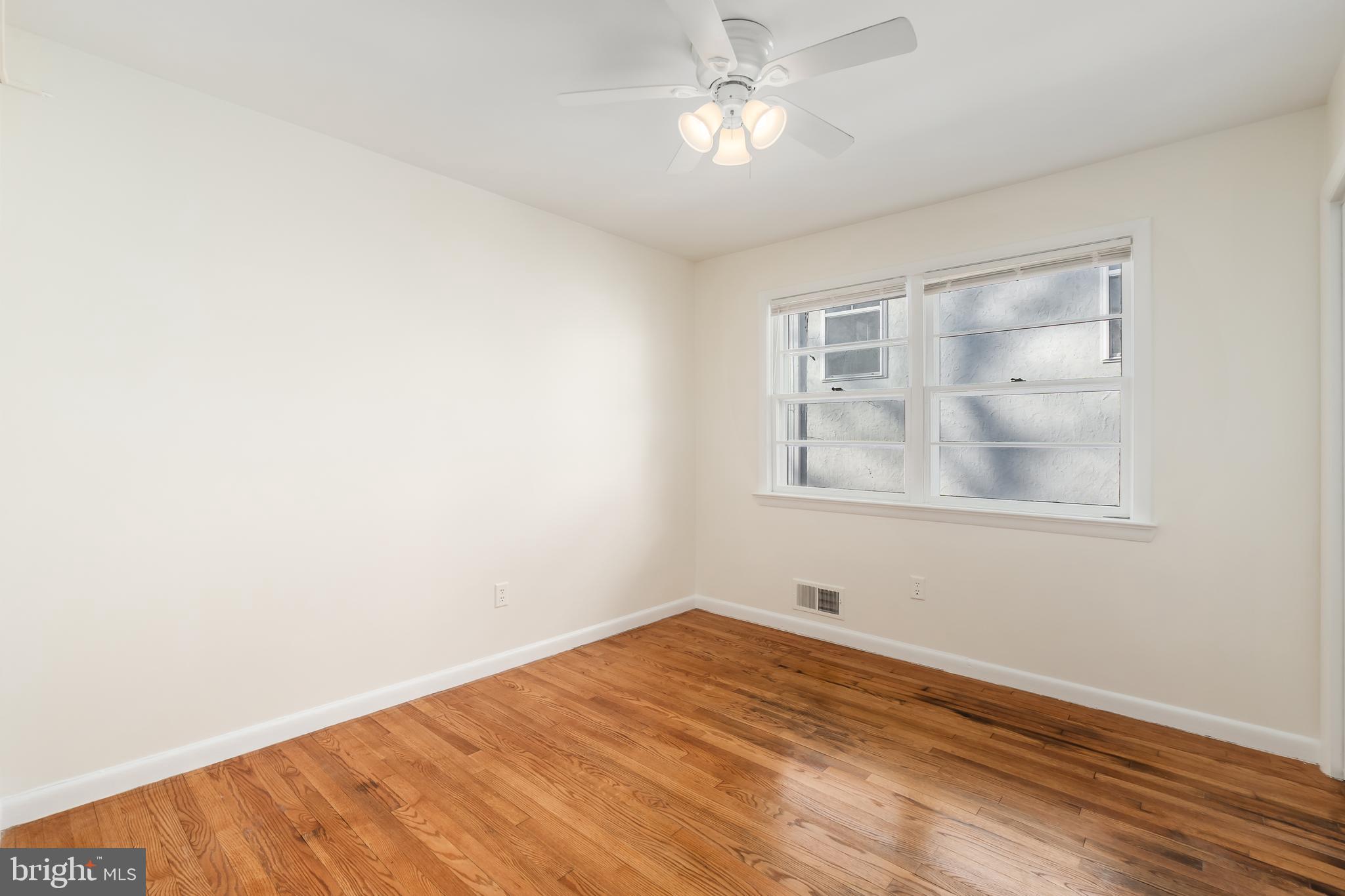 4208 16th Street Northwest Washington, DC 20011 - Photo 19 of 47 a view of empty room with wooden floor and fan