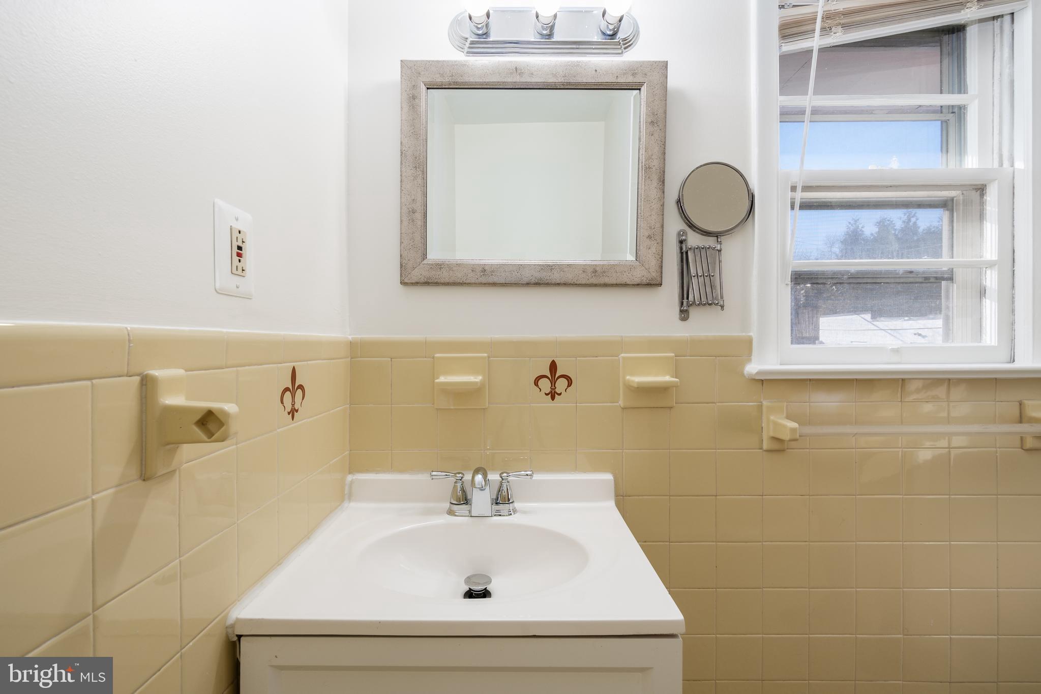 4208 16th Street Northwest Washington, DC 20011 - Photo 24 of 47 a bathroom with a sink and a mirror