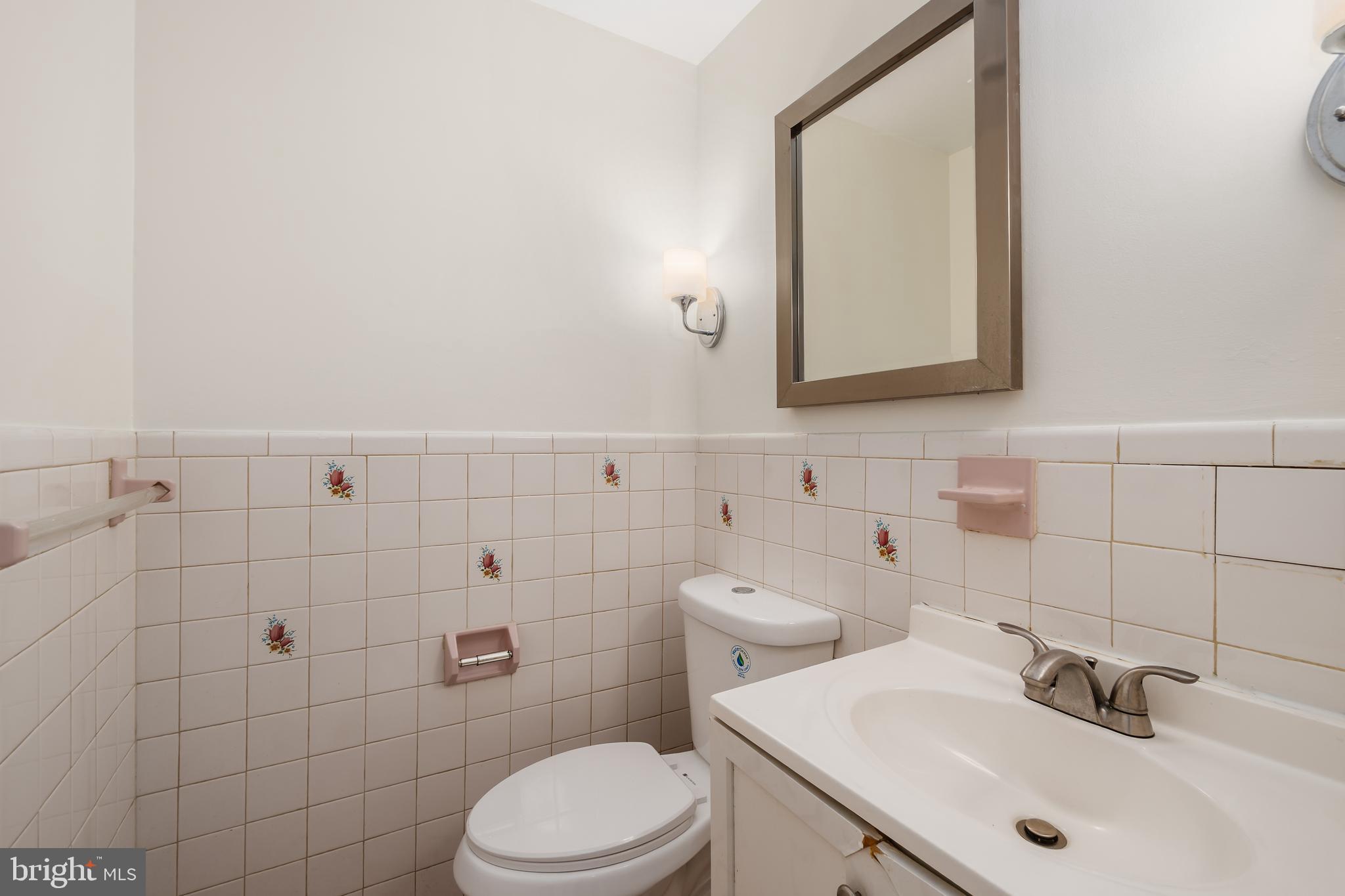 4208 16th Street Northwest Washington, DC 20011 - Photo 34 of 47 a bathroom with a sink mirror and toilet