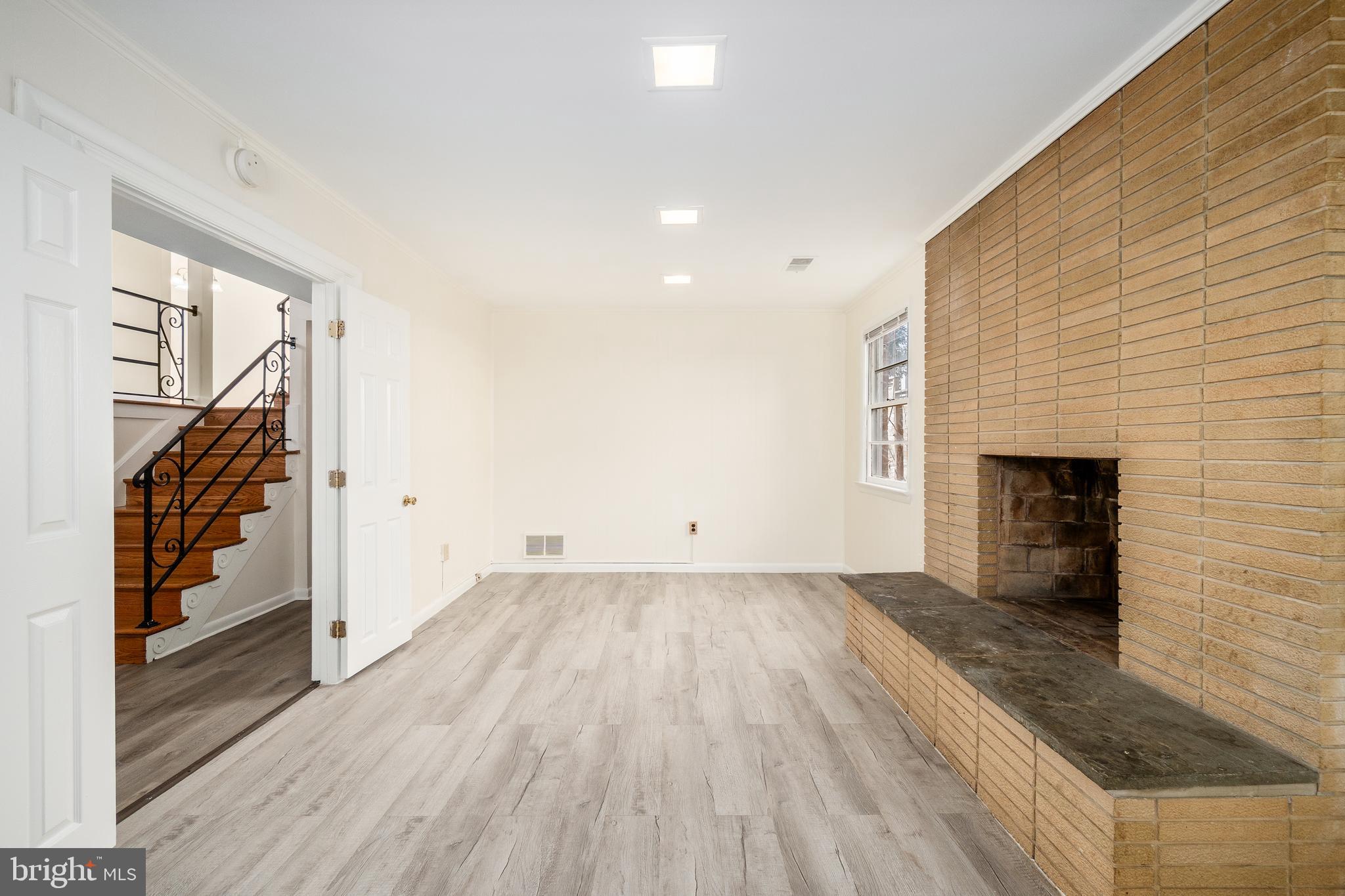 4208 16th Street Northwest Washington, DC 20011 - Photo 5 of 47 wooden floor in an empty room with a fireplace