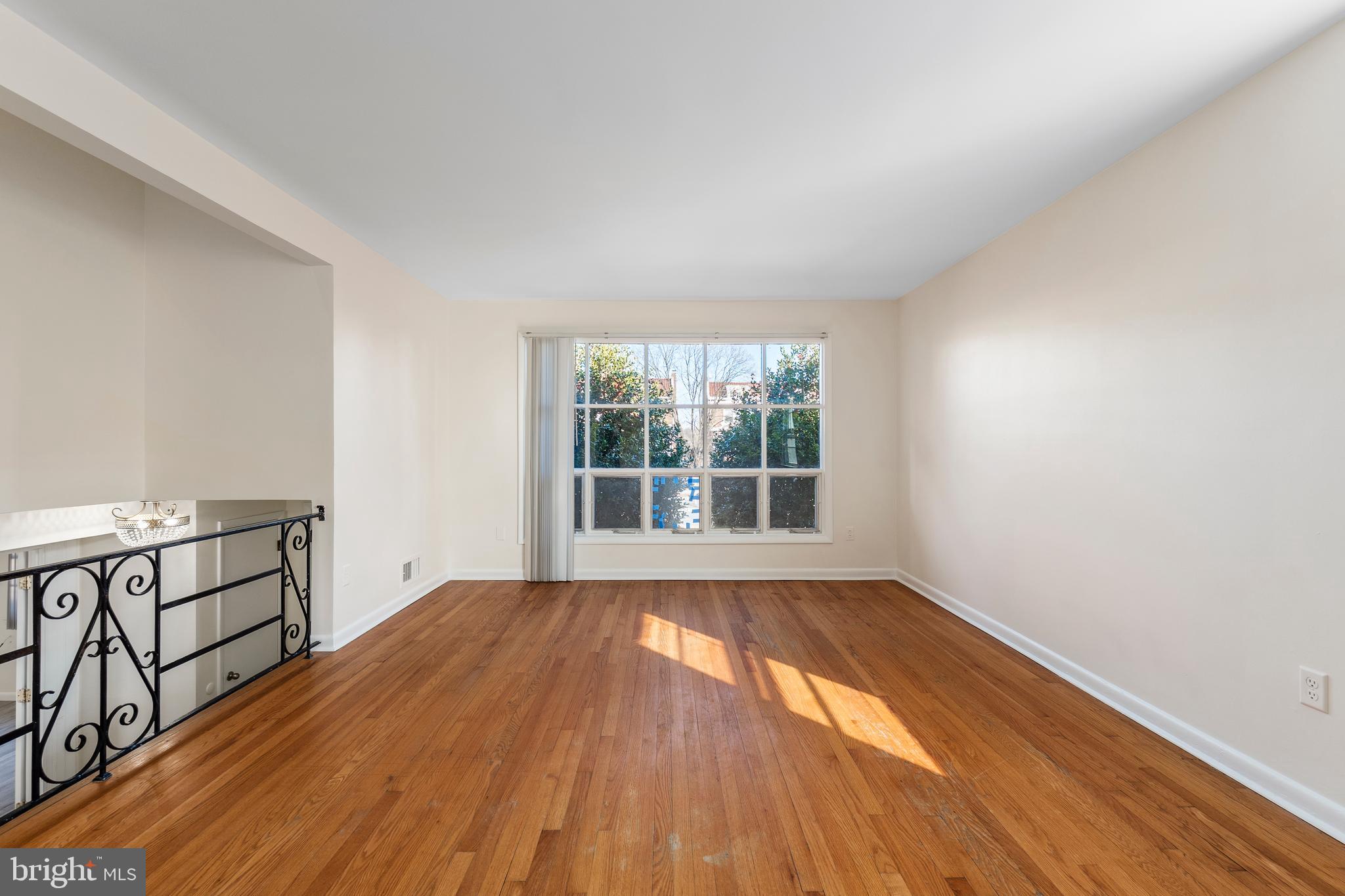 4208 16th Street Northwest Washington, DC 20011 - Photo 6 of 47 wooden floor in an empty room with a window