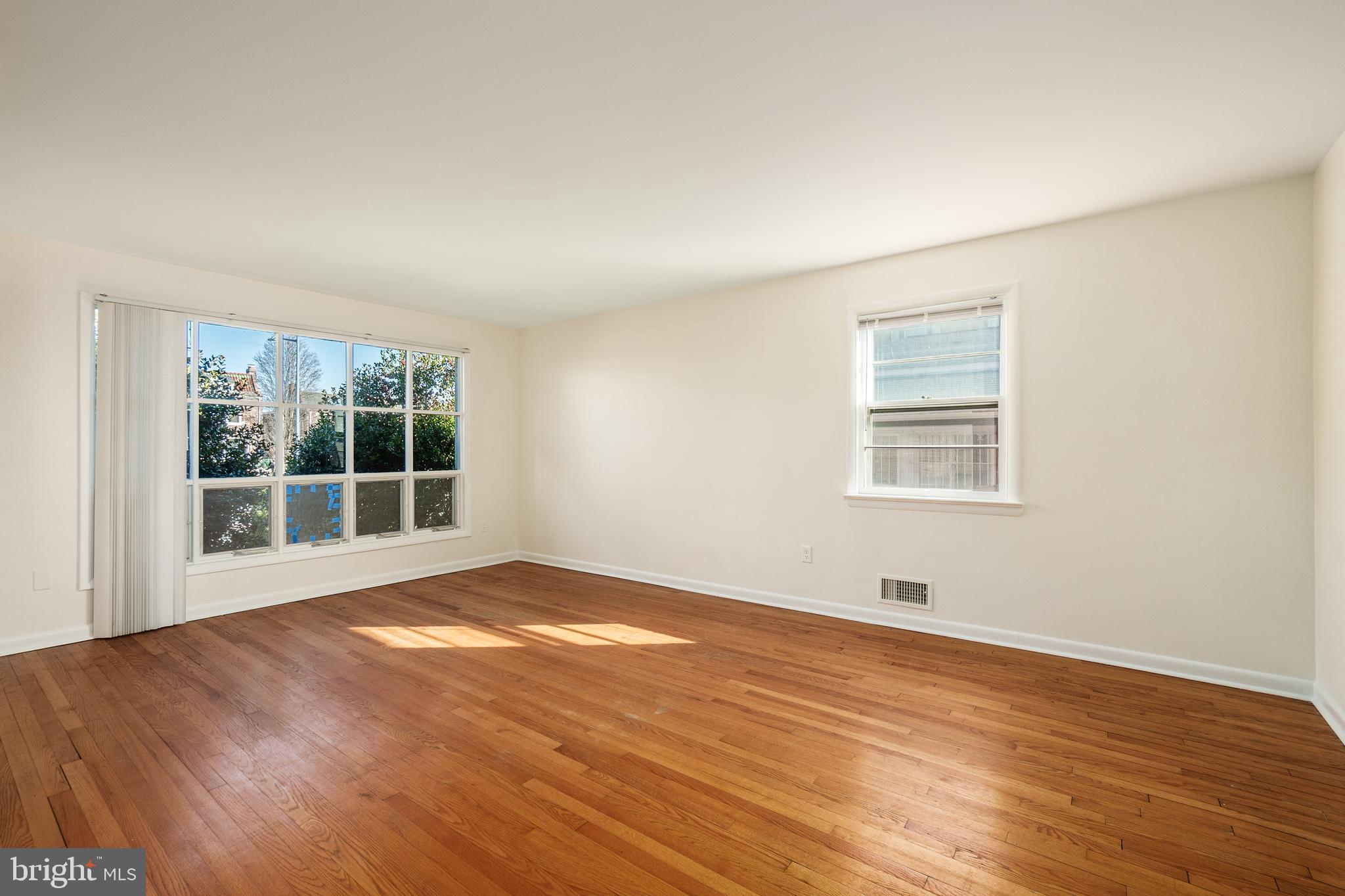 4208 16th Street Northwest Washington, DC 20011 - Photo 9 of 47 a view of an empty room with wooden floor and a window