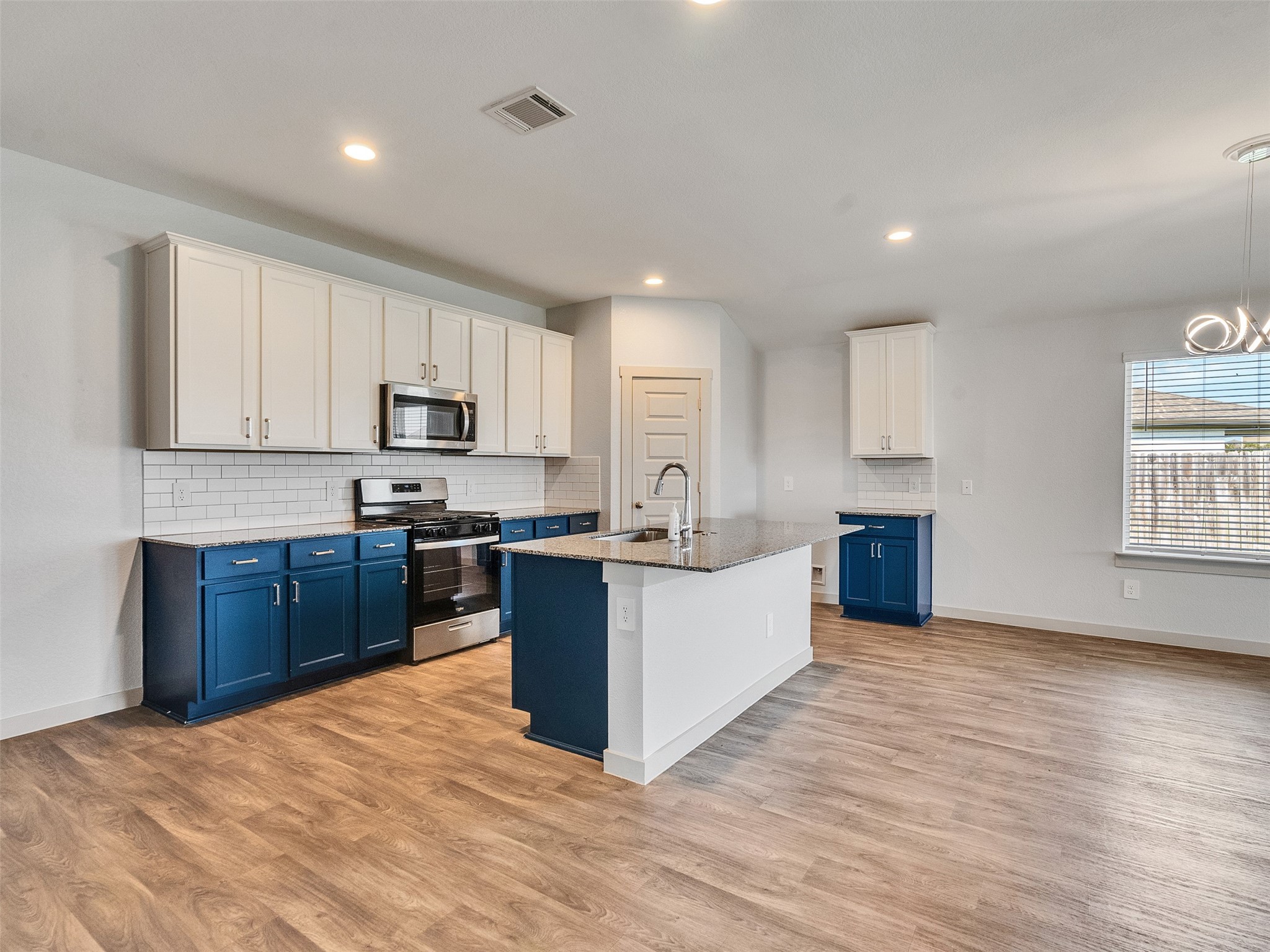 10627 Great Basin Drive Rosharon, TX 77583 - Photo 12 of 42 a kitchen with stainless steel appliances granite countertop a stove top oven a sink dishwasher and a refrigerator