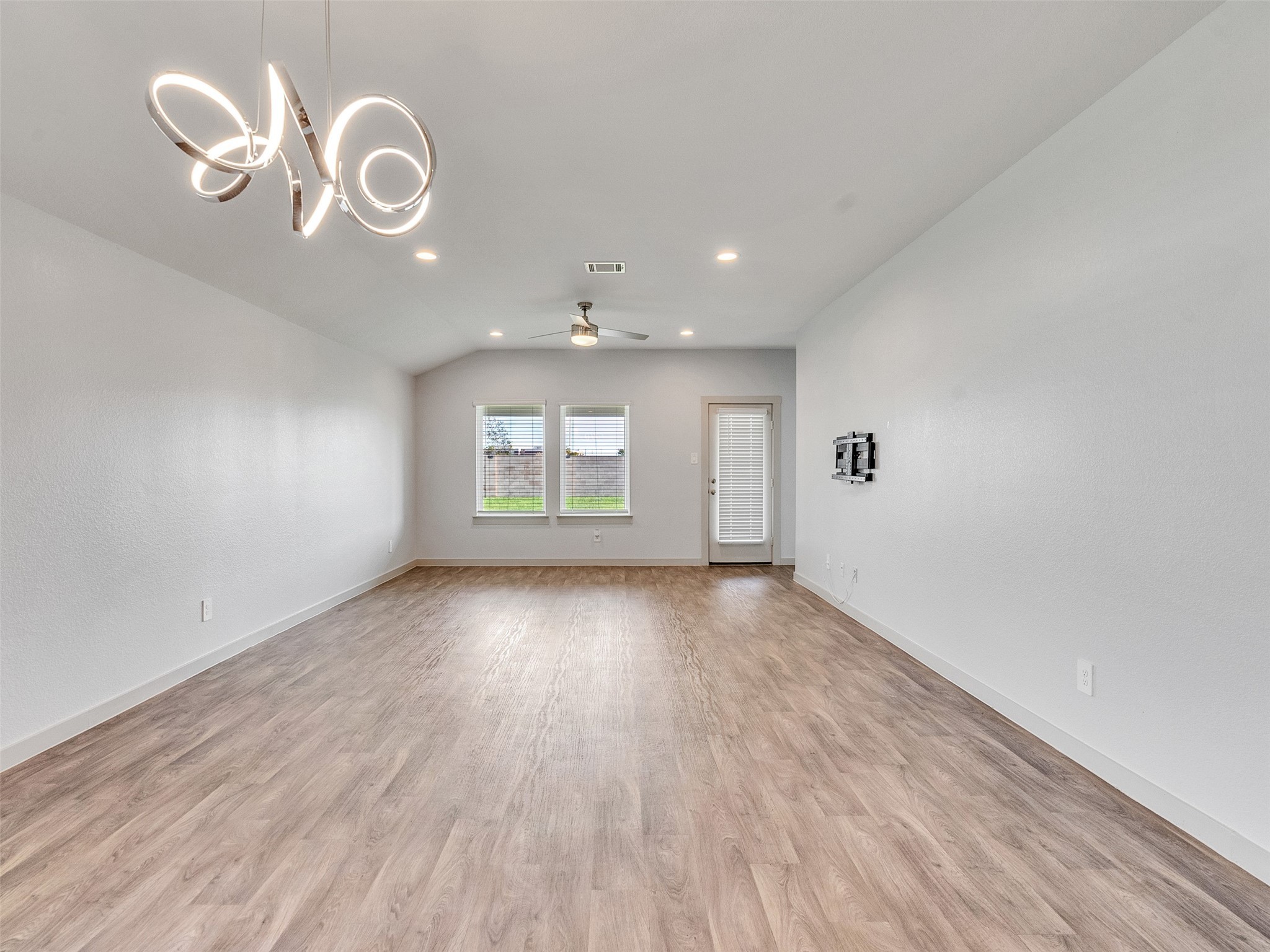 10627 Great Basin Drive Rosharon, TX 77583 - Photo 14 of 42 an empty room with wooden floor and windows