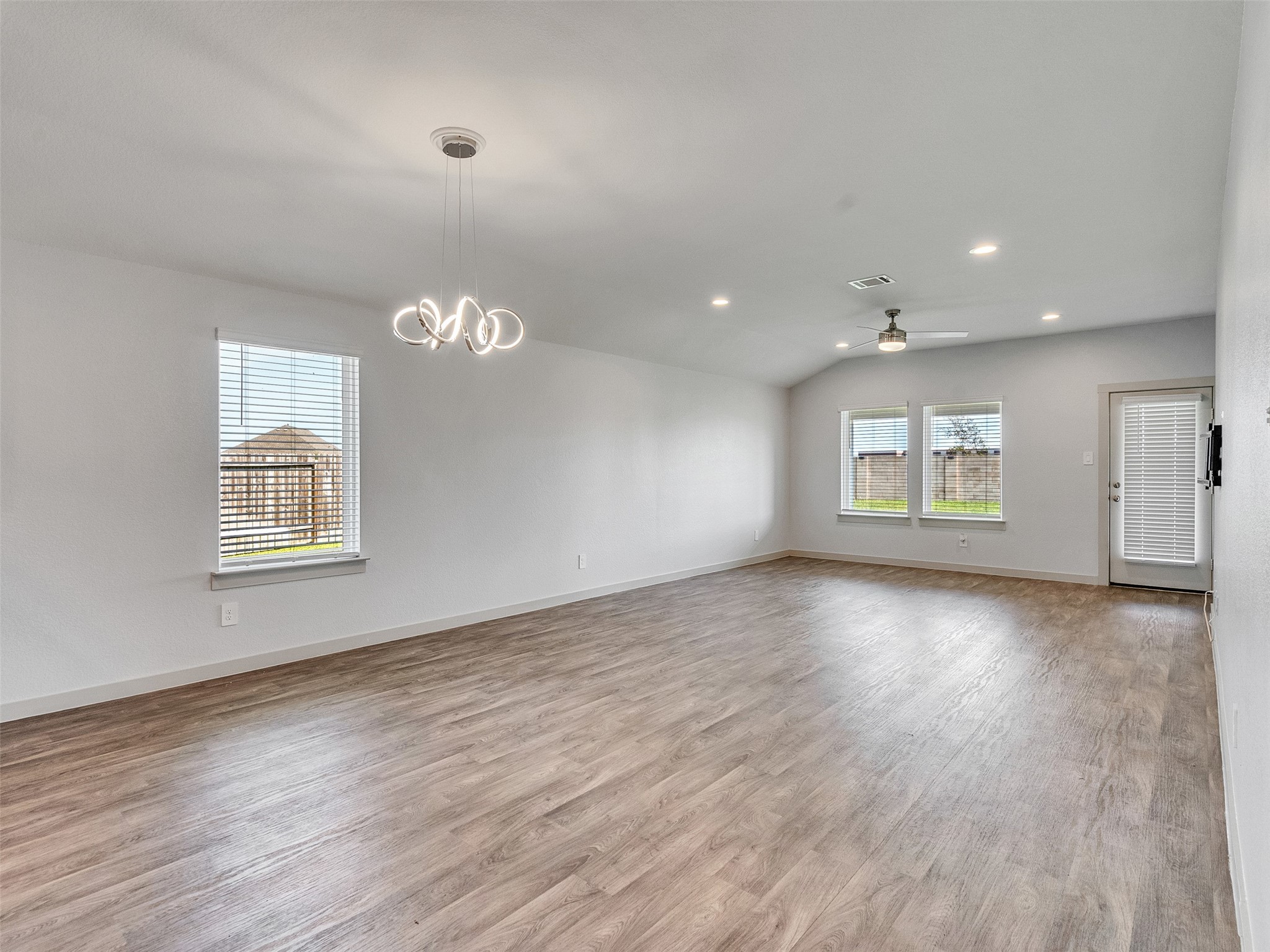 10627 Great Basin Drive Rosharon, TX 77583 - Photo 15 of 42 an empty room with wooden floor and windows